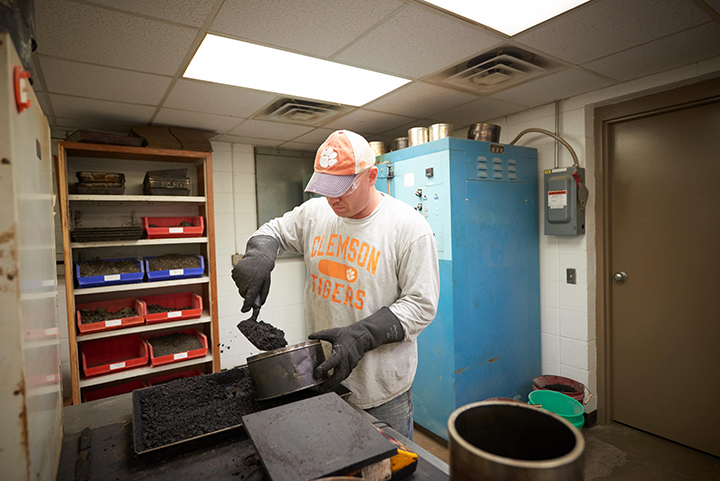 Man scooping asphalt